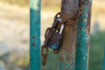 Padlock on the gate in the meadow fence. Slovakia