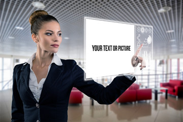 Young business lady works with virtual graphic interface in futuristic office