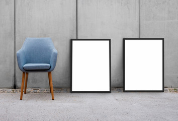 chair and blank picture frames on sidewalk with concrete wall background 