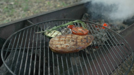 Healthy fish cuisine: fried steaks from white sea fish on the grill with garnish with grilled vegetables, the cooking process, at the end of the video in the background,