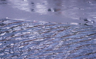 Frozen blue water background with ice surface