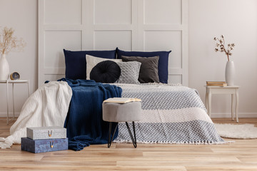 Grey and blue bedding and blanket on comfortable king size bed
