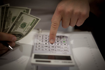 Office, business tools with dollars and calculator on table .