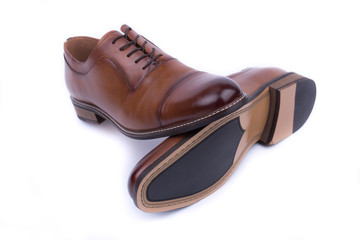A pair of classic leather elegant shoes on a white background. Beautiful brown luxury and casual leather men shoes. Fashion accessory. Front view.