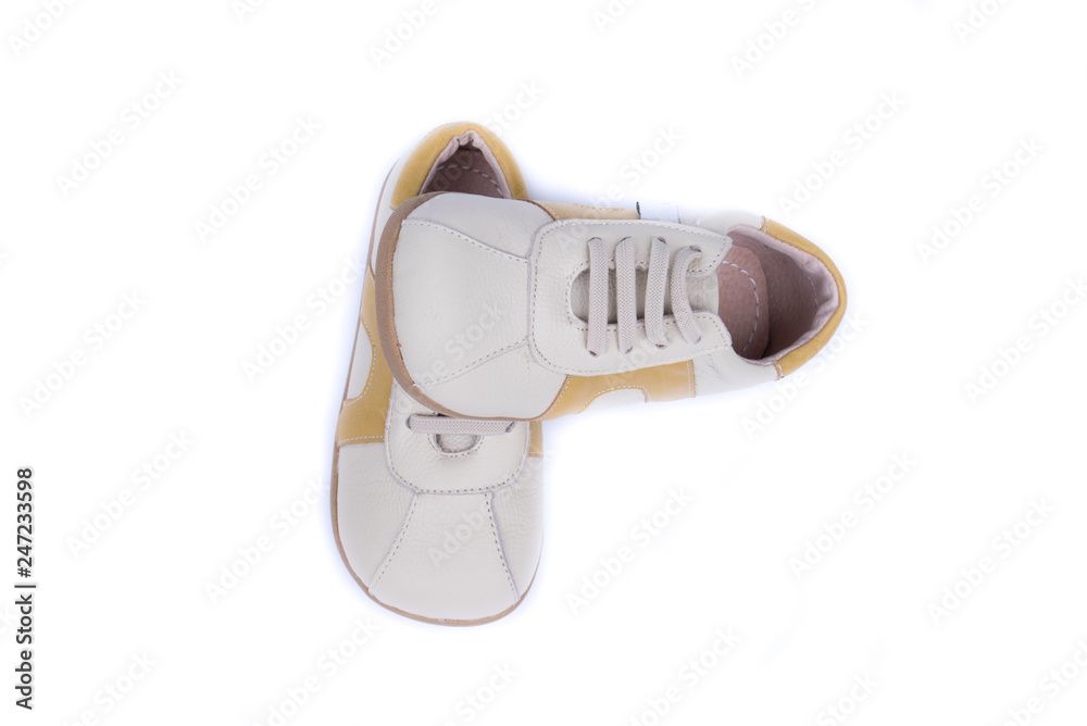 Wall mural classic leather elegant shoes on a white background. beautiful cream, gray, brown kids casual leathe