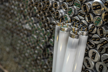 Old fluorescent lamps are stacked in rows. Background view