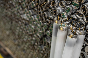 Old fluorescent lamps are stacked in rows. Background view