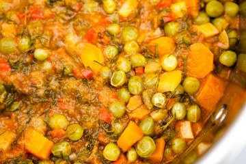 Stew with peas, carrots, onions, tomato sauce and spices