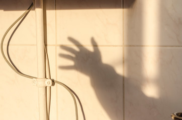 Human shadow of the hand waving hello