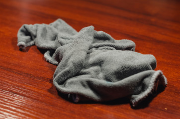 Fototapeta na wymiar Grey rag on the wooden desk