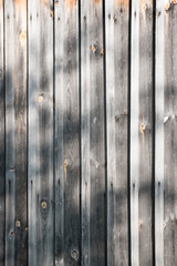 Vintage natural wood background – wall. Old weathered wooden plank in gray color. Wood texture, background with natural shadows. Wood for interior exterior decoration, industrial construction concept