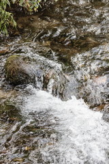 Background image of running fresh water in a river over riverstones.