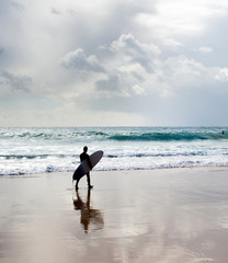 Surfer surfboard walking beach Portugal
