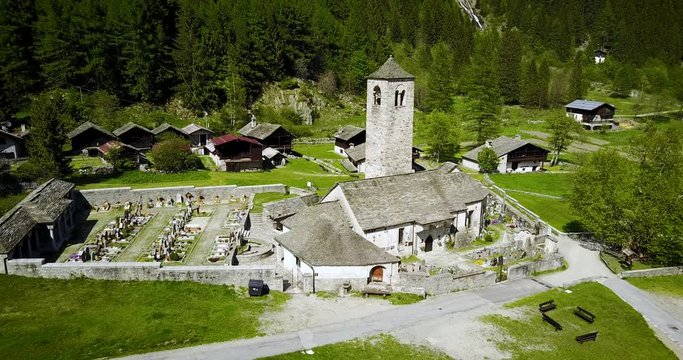 Aerial shot of an ancient catholic church in the Italian alps