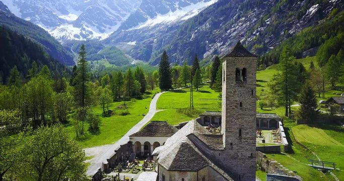 Aerial shot of an ancient catholic church in the Italian alps