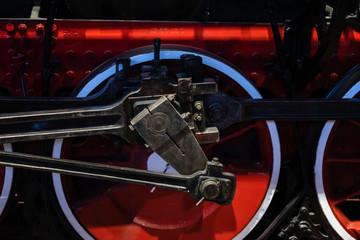 Part of antique locomotive steam close up. Bright red wheels Abstract vintage background