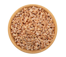 Buckwheat porridge in wooden bowl isolated on white background. Top view