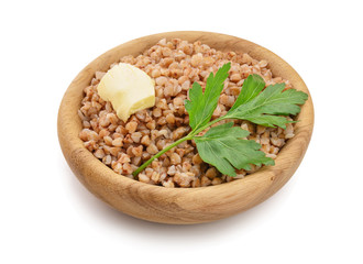 Buckwheat porridge in wooden bowl isolated on white background