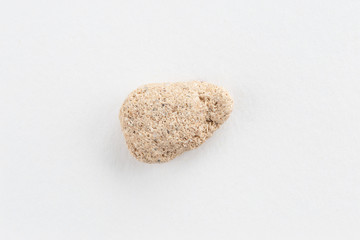 Sea pebble on a white background