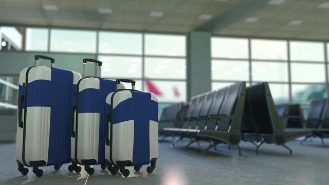 Travel suitcases featuring flag of Finland. Finnish tourism conceptual animation