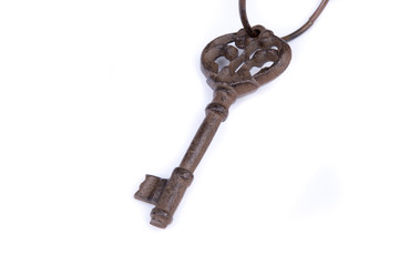 Old key with ring on white background. Isolated old key laying on the background. Top, side view. Close up.