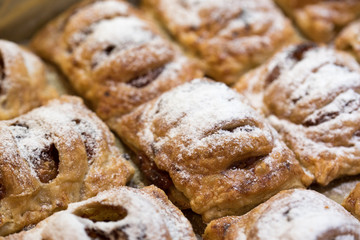 Freshly baked apple buns. Slice of puff/flaky pastry covered with cut,fried apples (with sugar), covered with slice of puff pastry (slightly cut in several places). Baked for 30 minutes at 200 degrees
