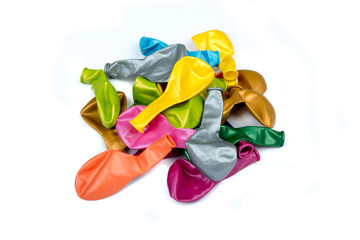 Colored balloons decoration isolated on white background. Unblown shaped balloon isolated over the white background, set of many different colors. Top view.