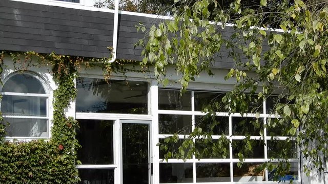 4K White House With Lots Of Windows Black Shingles And Overhanging Green Treen Panorama