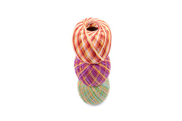 Three balls of yarn on each other in a stack. Thread for crochet and  knitting works. Colorful - yellow, orange, red, purple, green yarn balls. Isolated on white background. Top, side view.
