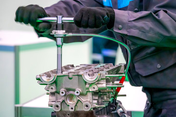 Engine repair. Car service worker. Engine disassembled. Machine maintenance. A man dismantles the...