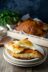 Patties with cottage cheese. Russian pastry, rustic wooden background. Traditional breakfast.