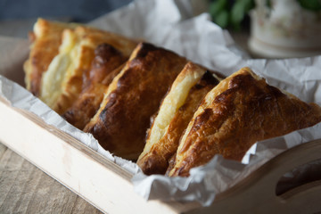 Patties or pie with cottage cheese. Russian pastry, rustic wooden background. Traditional breakfast.