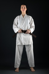 Young woman dressed in traditional kimono practicing her karate moves