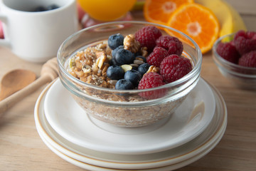 Cereal, muesli and various delicious fruit, berries for breakfast. healthy, energy breakfast, wooden table.