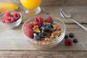 Cereal, muesli and various delicious fruit, berries for breakfast. healthy, energy breakfast, wooden table.
