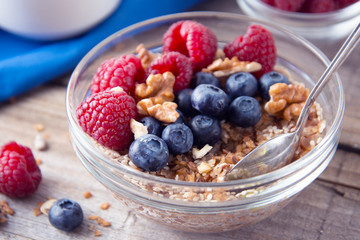 Cereal, muesli, granola and various delicious fruit, berries for breakfast. healthy, energy breakfast, wooden table.