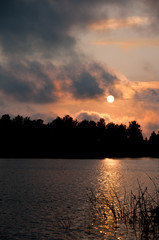 Fototapeta premium sunrise in the forest by the lake