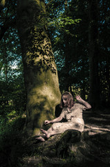 Young female in the forest next to a river