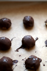 Homemade no-bake peanut butter and chocolate balls, sprinkled with pink salt. Selective focus. 