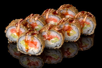 Hot fried Sushi Roll with smoked salmon, shrimp, avocado and cheese on black background. Sushi menu. Japanese food. 