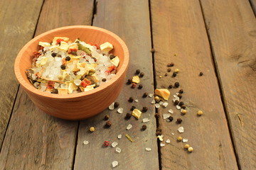 background mix of many colorful spices and salt into a grinder in a wooden bowl