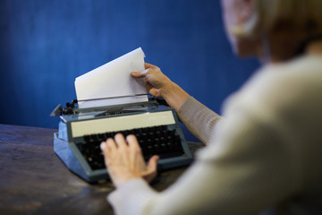Crop shot of unrecognizable man typing using retro typewriter, copy space