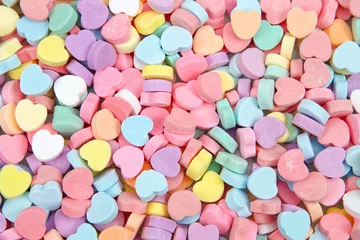 Fototapeten Background of brightly colored candy hearts for Valentine's Day. © sheilaf2002
