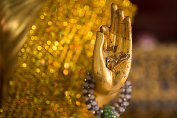 Fototapeta premium Golden buddha hand which has stuck gold leaf