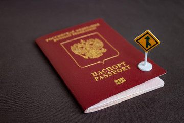 Russian international passport with a yellow arrow road sign - migration concept