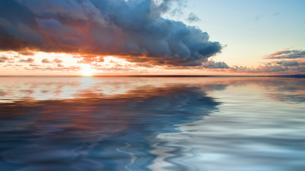 Fototapeta na wymiar Sea landscape with dramatic sunset views and a large cloud.