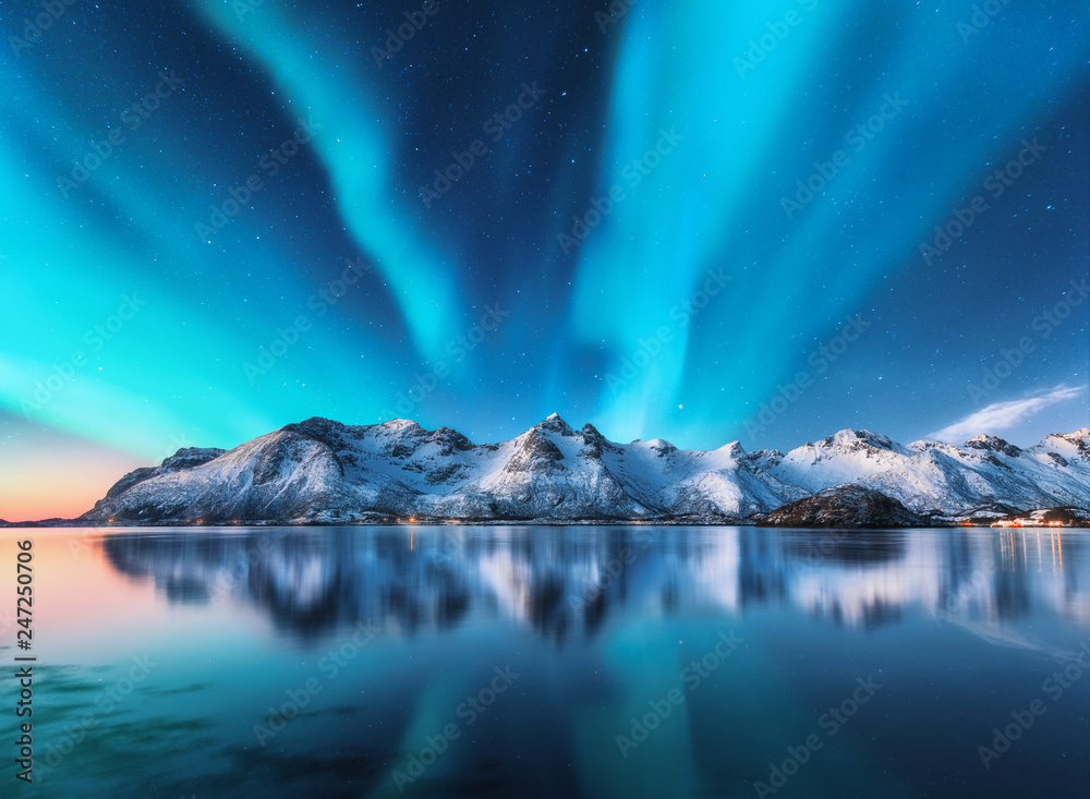 Wall mural northern lights and snow covered mountains in lofoten islands, norway. aurora borealis. starry sky w