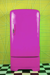 old vintage purple refrigerator on a yellow background