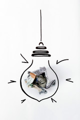 Composition with crumpled banknote and drawing of lamp bulb on white background, top view. Creative concept