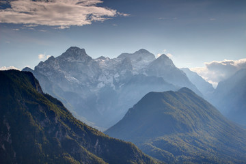Steep walls of deep Vrata Kot valleys in autumn haze with snowy Triglav Rjavina and forested Jerebikovec peaks, Julijske Alpe range Triglav National Park Gorenjska Kranjska Carniola Slovenia Europe © nogreenabove2k